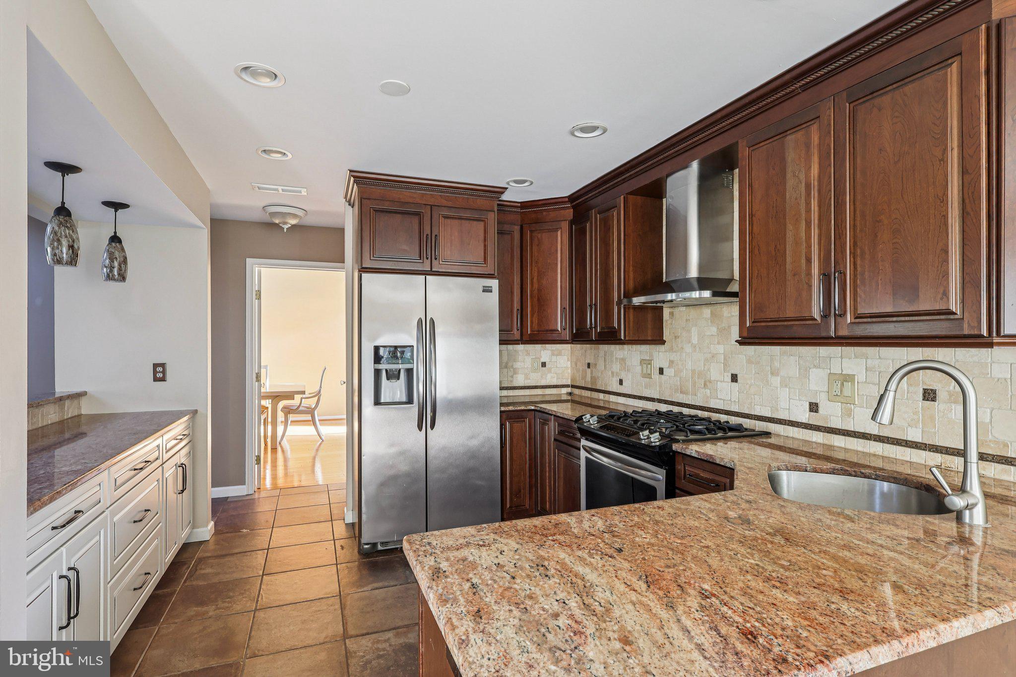22 Hawk Lane Marlton, NJ 08053 - Photo 20 of 46 a kitchen with stainless steel appliances granite countertop a sink stove and refrigerator