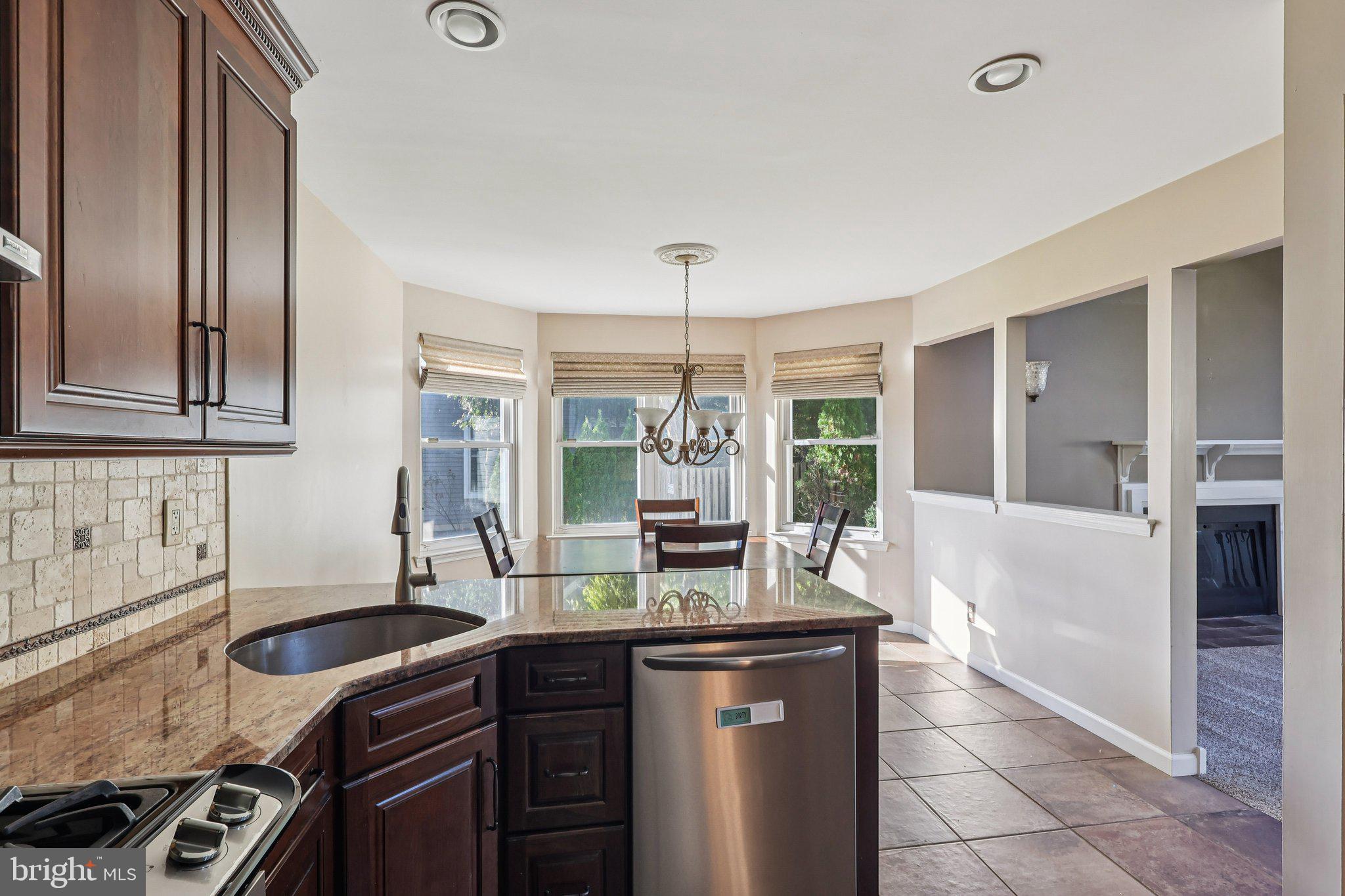22 Hawk Lane Marlton, NJ 08053 - Photo 22 of 46 a kitchen with a sink and wooden cabinets