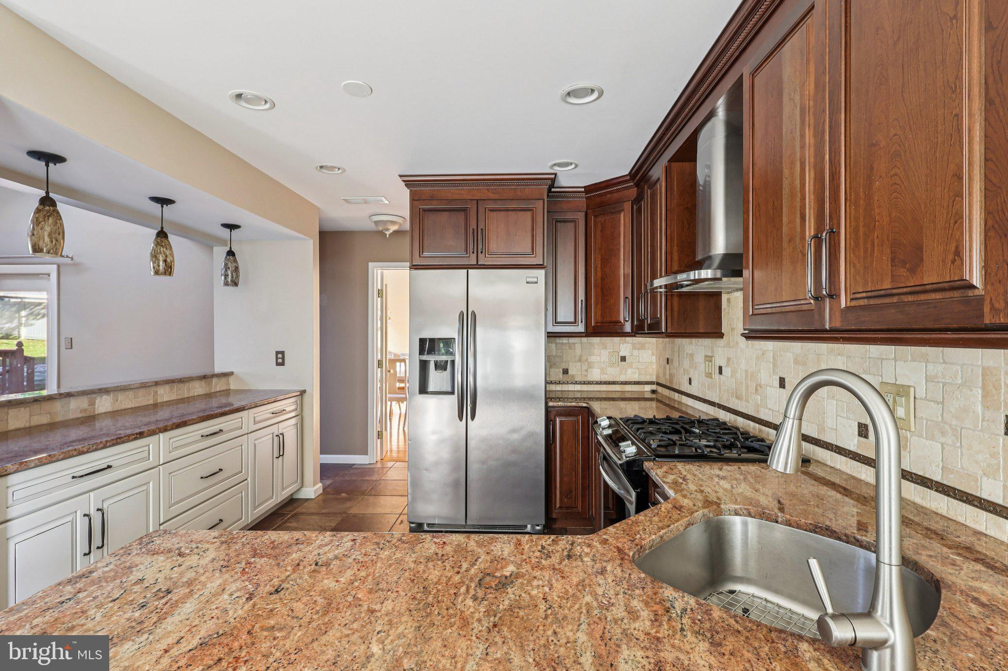 22 Hawk Lane Marlton, NJ 08053 - Photo 23 of 46 a kitchen with stainless steel appliances granite countertop a sink a stove and refrigerator