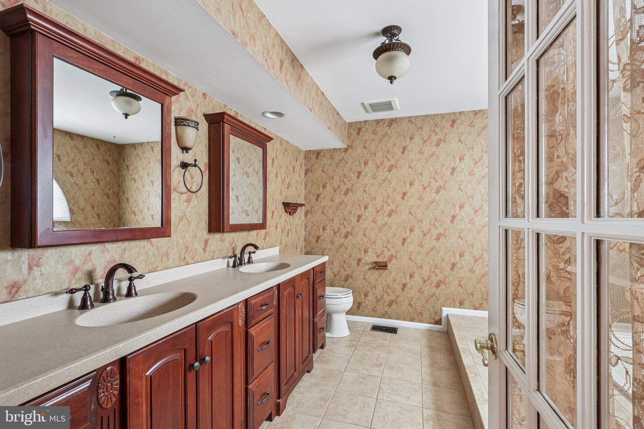 22 Hawk Lane Marlton, NJ 08053 - Photo 37 of 46 a bathroom with a double vanity sink double mirror and a bathtub