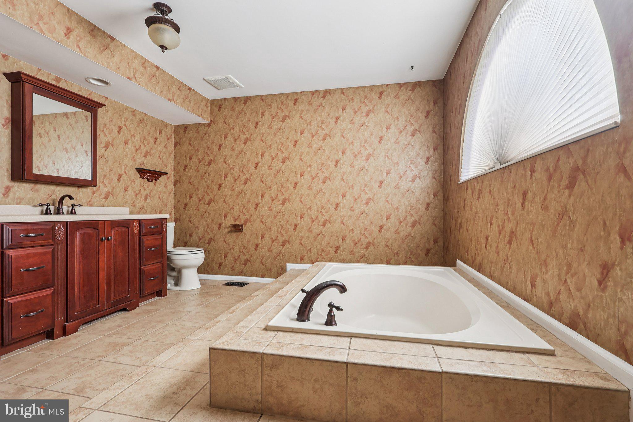 22 Hawk Lane Marlton, NJ 08053 - Photo 40 of 46 a bathroom with a sink a toilet a mirror and vanity