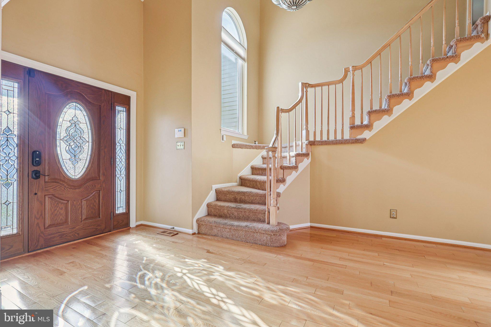 22 Hawk Lane Marlton, NJ 08053 - Photo 5 of 46 a view of a hallway with entryway wooden floor and front door