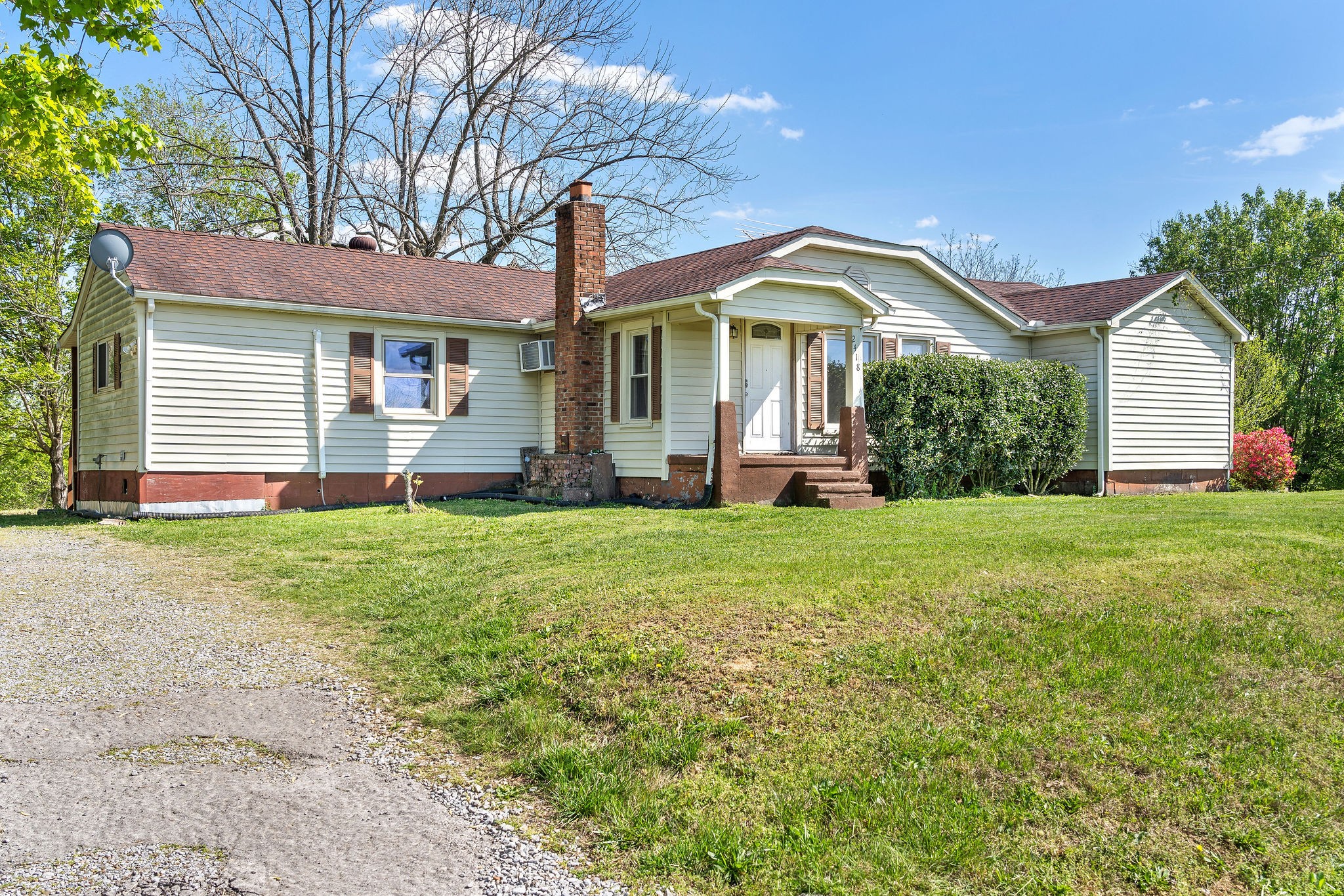 a front view of house with yard and green space