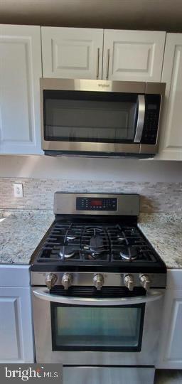 6321 East Fariston Drive Philadelphia, PA 19120 - Photo 13 of 31 a stove top oven sitting inside of a kitchen