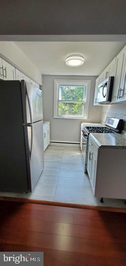 6321 East Fariston Drive Philadelphia, PA 19120 - Photo 20 of 31 a view of a kitchen with wooden floor and electronic appliances