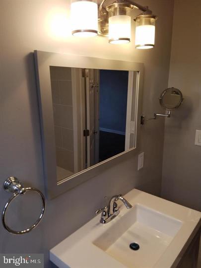 6321 East Fariston Drive Philadelphia, PA 19120 - Photo 23 of 31 a bathroom with a sink and a mirror