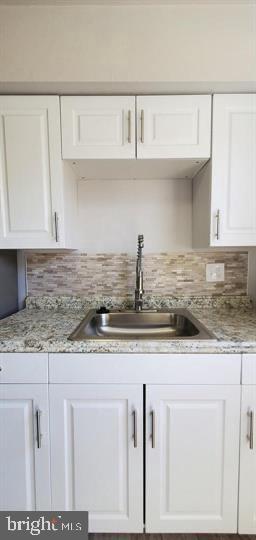6321 East Fariston Drive Philadelphia, PA 19120 - Photo 4 of 31 a kitchen with granite countertop a sink a stove and cabinets