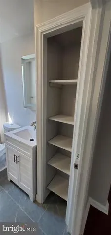a bathroom with a sink a toilet and vanity
