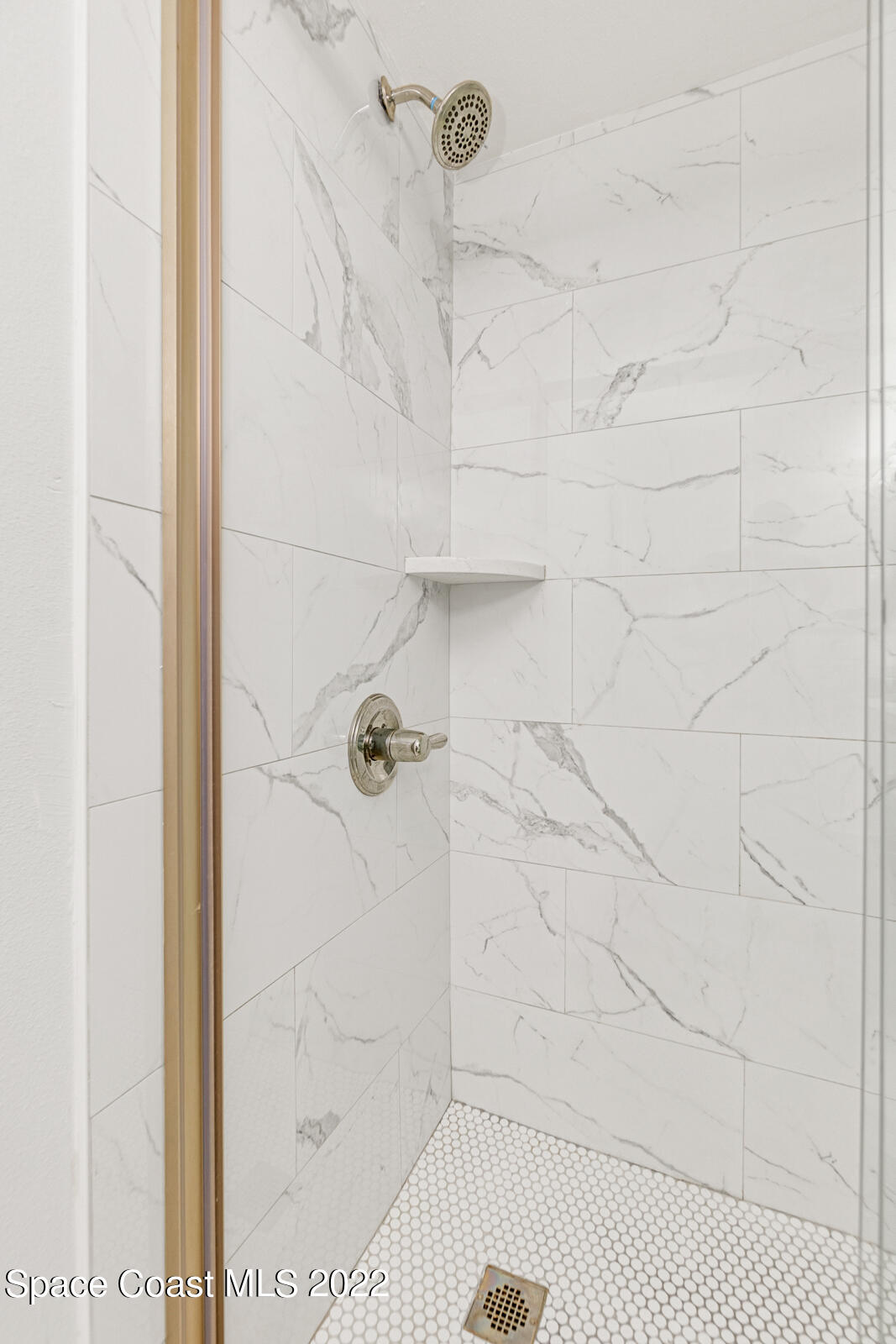 7520 Ridgewood Avenue, Unit 104 Cape Canaveral, FL 32920 - Photo 12 of 35 a bathroom with a shower