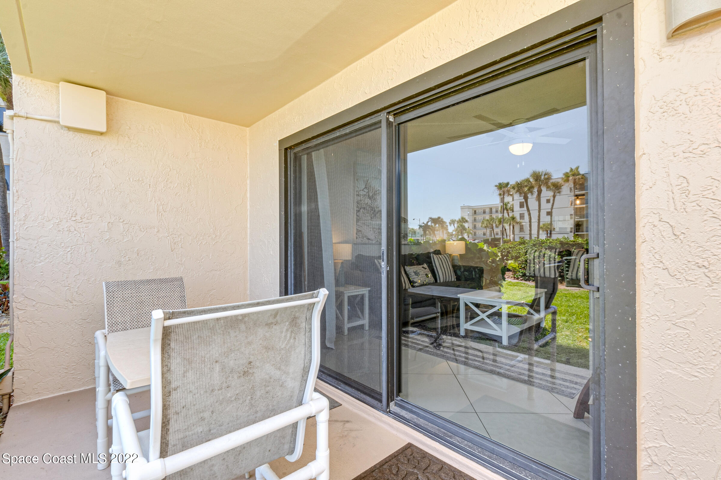 7520 Ridgewood Avenue, Unit 104 Cape Canaveral, FL 32920 - Photo 16 of 35 view of living room with furniture and a window