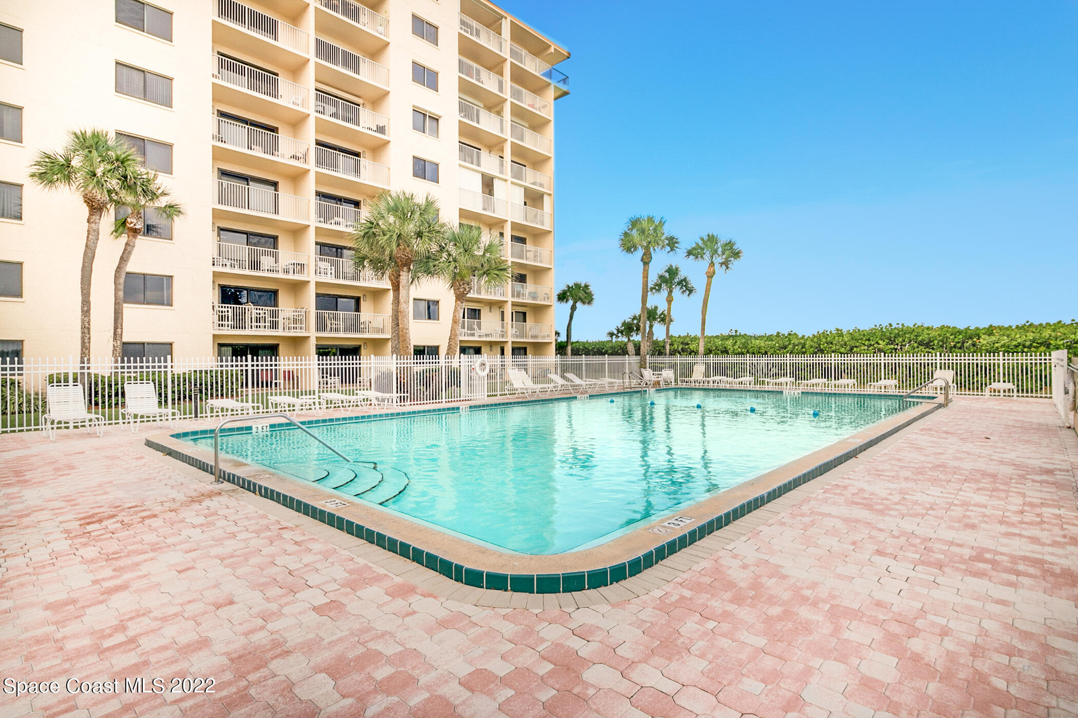 7520 Ridgewood Avenue, Unit 104 Cape Canaveral, FL 32920 - Photo 20 of 35 a view of a swimming pool and an outdoor space