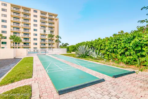 a view of a swimming pool with a garden and plants