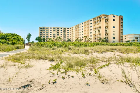 a view of a large building with a yard