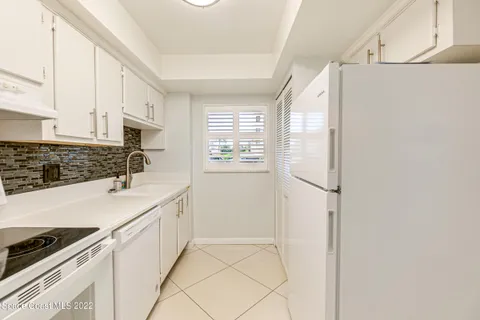 a kitchen with stainless steel appliances a refrigerator sink and cabinets