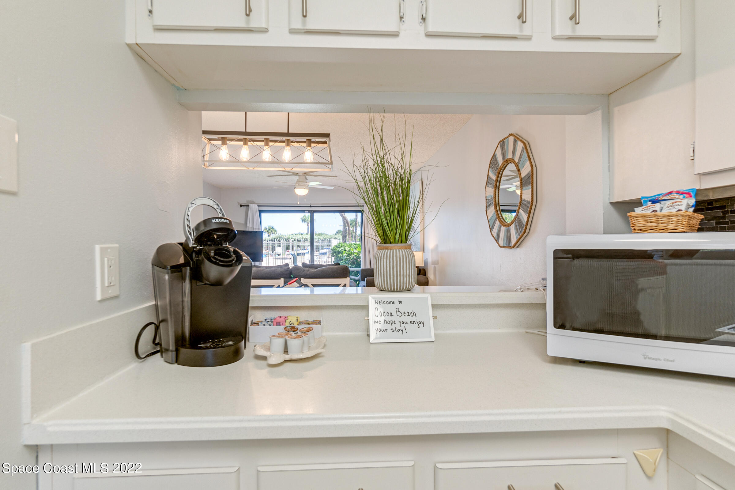 7520 Ridgewood Avenue, Unit 104 Cape Canaveral, FL 32920 - Photo 5 of 35 a kitchen with a refrigerator and a stove