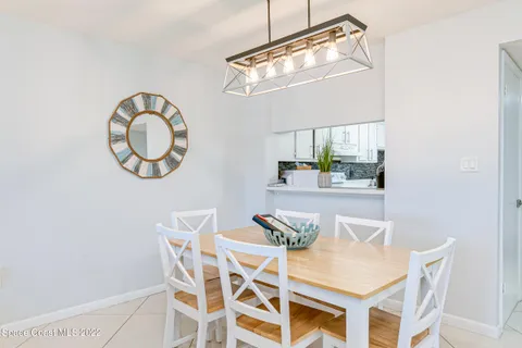 a view of a dining room with furniture and a chandelier