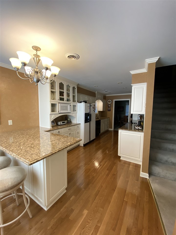 100 Ericson Road Memphis, TN 38018 - Photo 11 of 24 YOU WILL LOVE THIS KITCHEN!! Check out the custom built cabinetry including a large glass fronted china hutch, the granite counter tops, the breakfast bar, and wood flooring