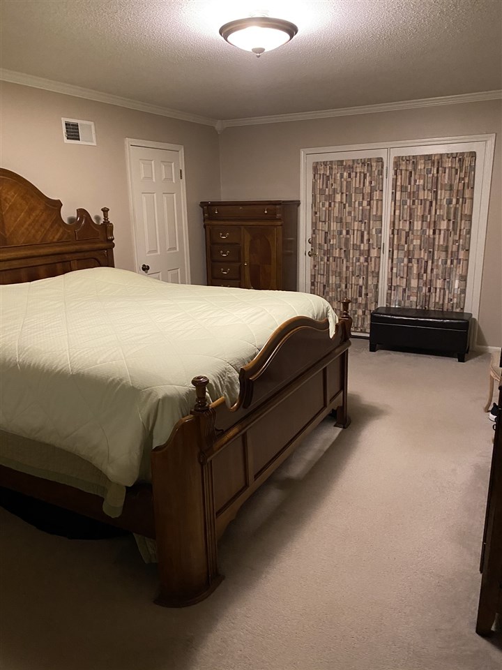 100 Ericson Road Memphis, TN 38018 - Photo 14 of 24 The first floor Master Suite offers a full bath with walk-in Shower, a large laundry closet, a sitting area and access to the Sunroom. Imagine yourself enjoying your morning coffee in that Sunroom overlooking the beautiful gardens.