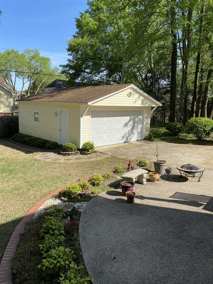Beautiful custom built double garage with pegboard along back wall, sheet rock on other walls 2 windows for ventilation.