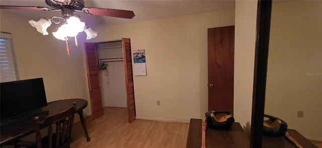 a bedroom with a bed tv and a window