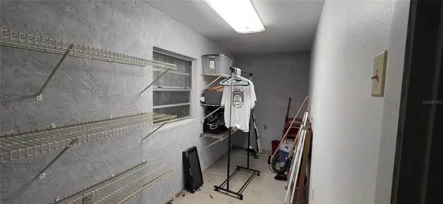 a view of an empty room with a cabinet