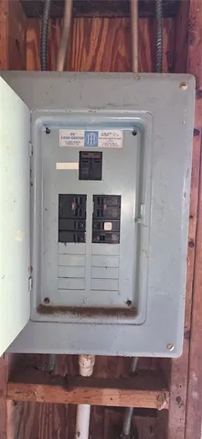 a view of a house with a big yard and a large trees