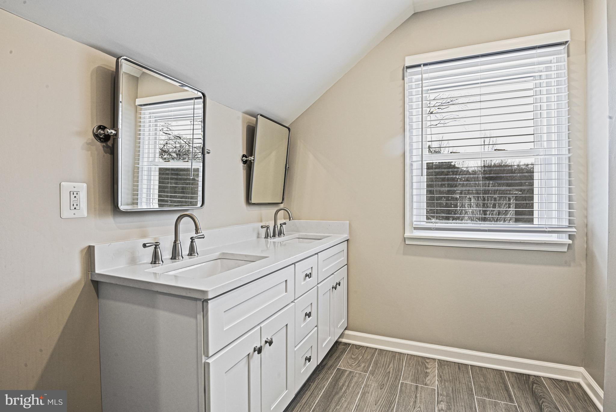 1905 Lamson Place McLean, VA 22101 - Photo 16 of 31 a bathroom with a double vanity sink a mirror and a window