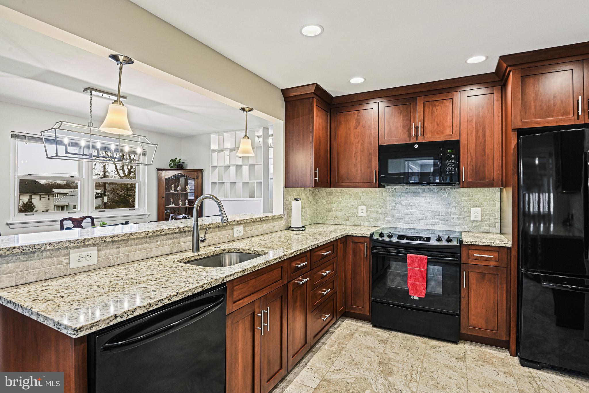 1905 Lamson Place McLean, VA 22101 - Photo 6 of 31 a kitchen with stainless steel appliances granite countertop a sink stove and microwave
