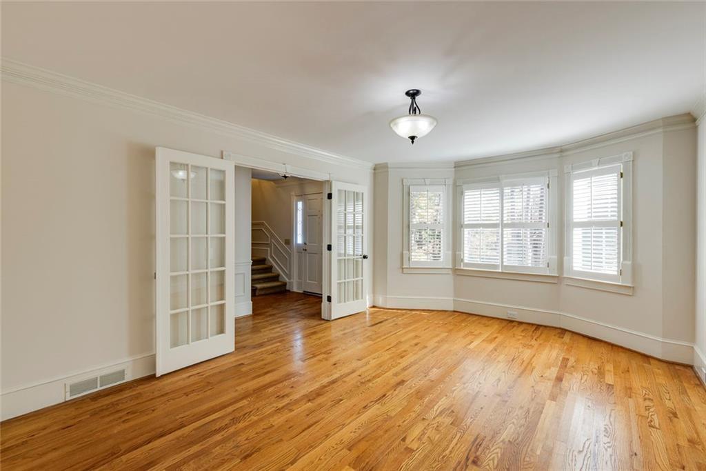 5377 Trentham Drive Dunwoody, GA 30338 - Photo 12 of 51 an empty room with wooden floor and windows
