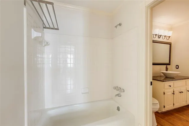 a bathroom with a bathtub sink and mirror