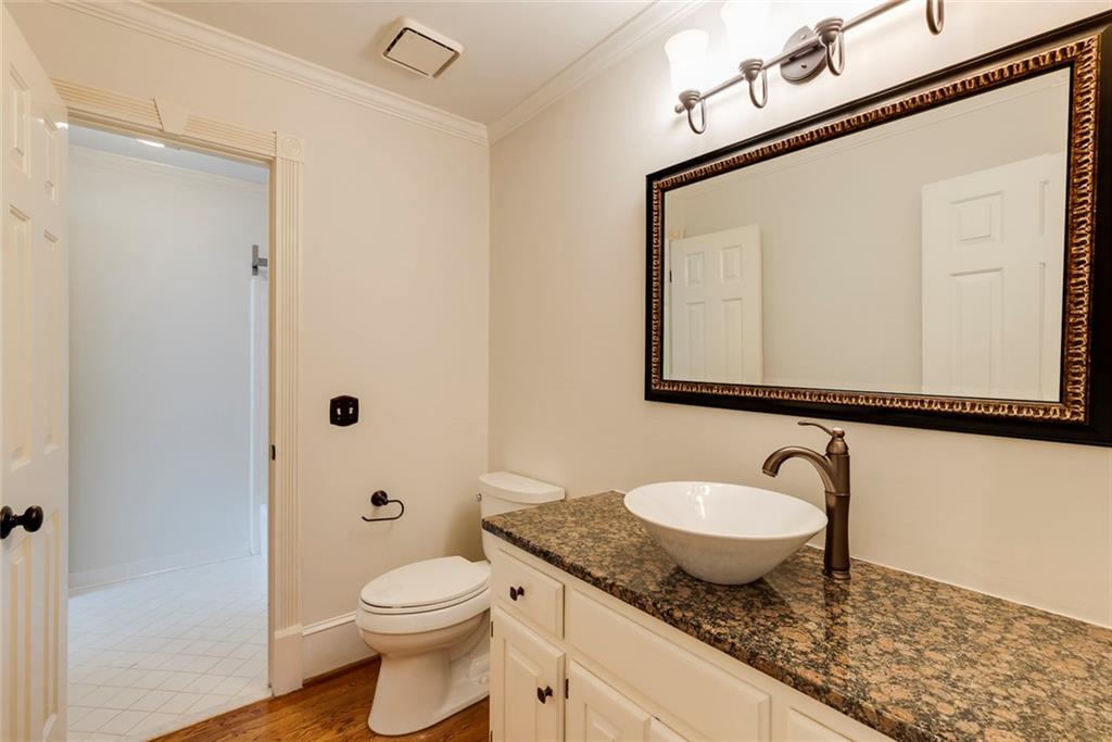 5377 Trentham Drive Dunwoody, GA 30338 - Photo 14 of 51 a bathroom with a granite countertop sink mirror vanity and toilet