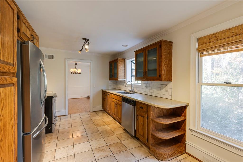 5377 Trentham Drive Dunwoody, GA 30338 - Photo 17 of 51 a large kitchen with a window and stainless steel appliances