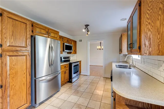 a kitchen with stainless steel appliances a refrigerator and a sink