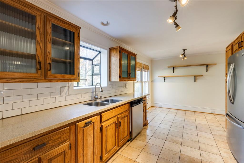 5377 Trentham Drive Dunwoody, GA 30338 - Photo 20 of 51 a kitchen with granite countertop a sink and cabinets