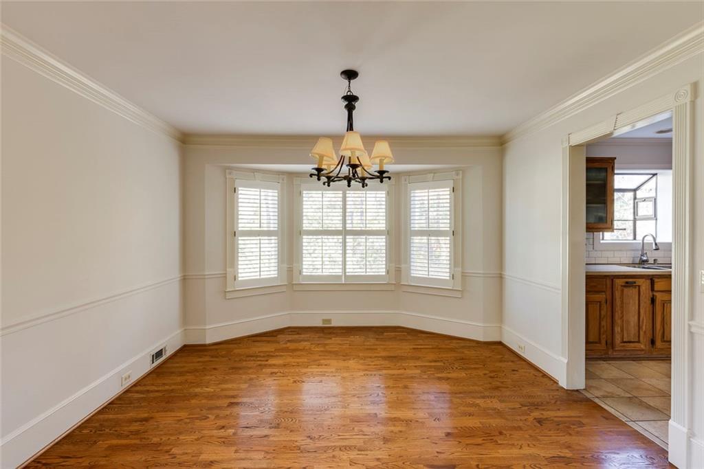 5377 Trentham Drive Dunwoody, GA 30338 - Photo 23 of 51 an empty room with chandelier and windows