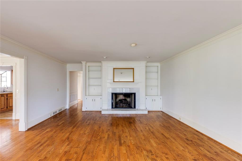 5377 Trentham Drive Dunwoody, GA 30338 - Photo 24 of 51 an empty room with a fireplace and wooden floor