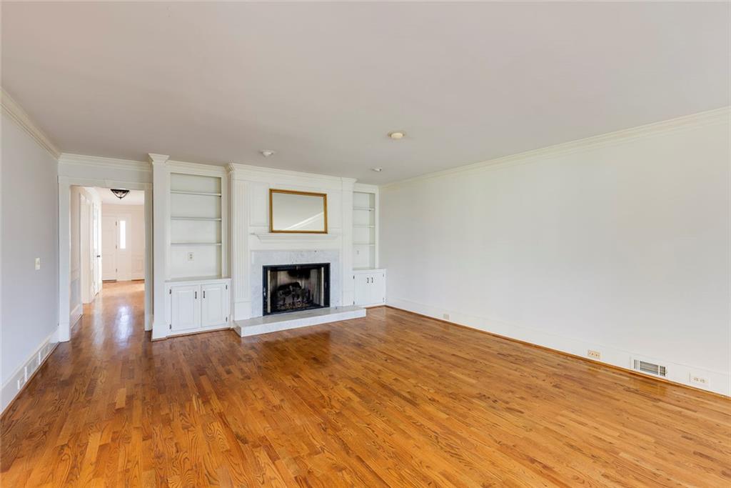 5377 Trentham Drive Dunwoody, GA 30338 - Photo 25 of 51 a view of empty room with wooden floor and fireplace