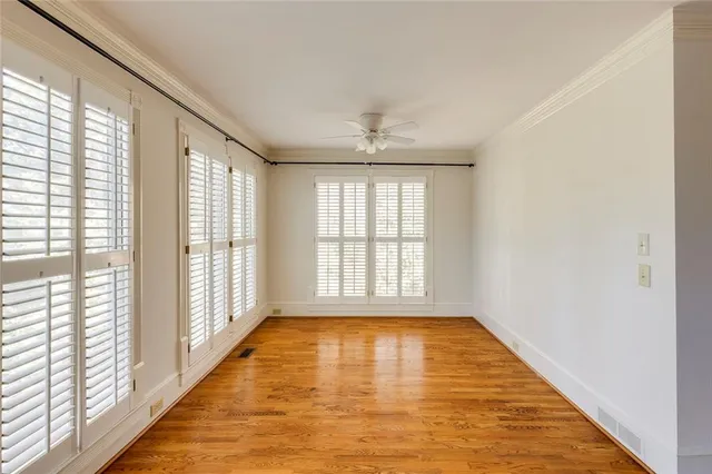 wooden floor in an empty room with a window