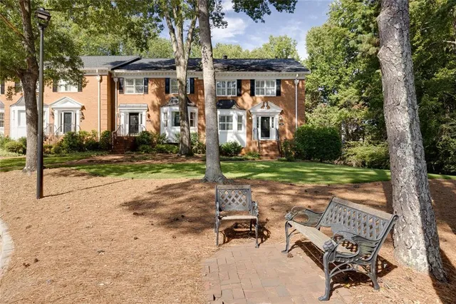 a view of a patio with a table and chairs under an umbrella