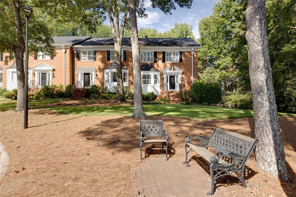 5377 Trentham Drive Dunwoody, GA 30338 - Photo 3 of 51 a view of a patio with a table and chairs under an umbrella