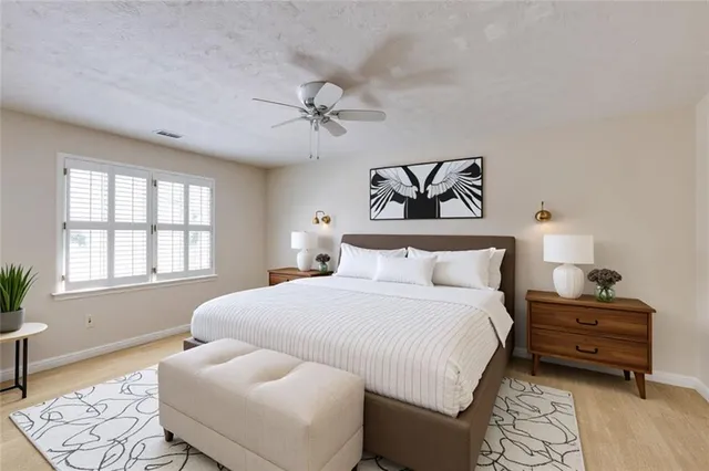 an empty room with a ceiling fan and a window