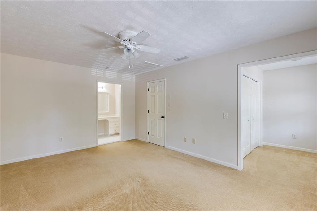 5377 Trentham Drive Dunwoody, GA 30338 - Photo 32 of 51 an empty room with a ceiling fan and a window