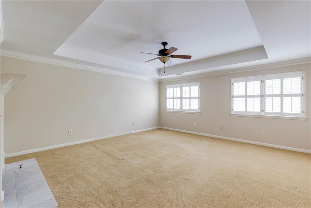 5377 Trentham Drive Dunwoody, GA 30338 - Photo 36 of 51 an empty room with windows and ceiling fan