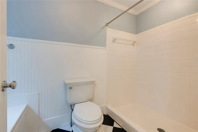 a bathroom with a toilet and a shower