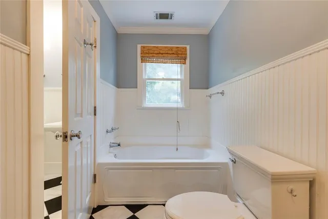 a bathroom with a black and white checkered floor