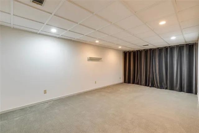 a living room with furniture a rug and a chandelier
