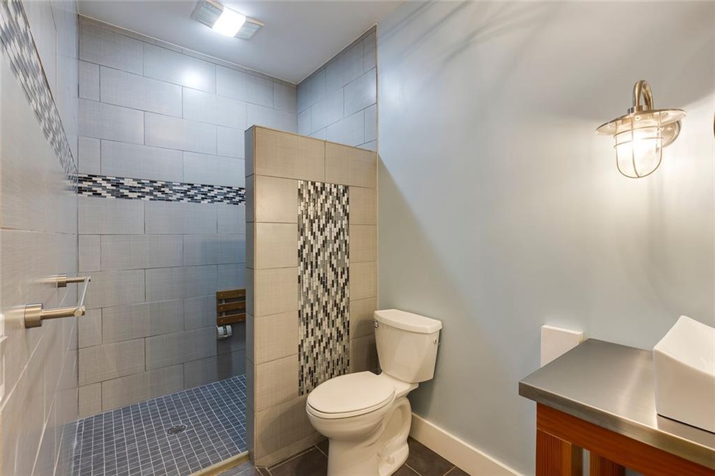 5377 Trentham Drive Dunwoody, GA 30338 - Photo 47 of 51 a white toilet sitting next to a bathroom sink and a shower