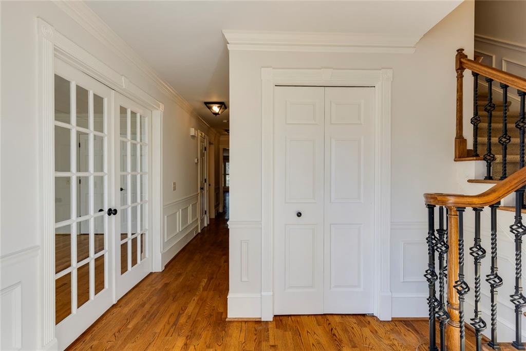 5377 Trentham Drive Dunwoody, GA 30338 - Photo 5 of 51 a view of a hallway with wooden floor and staircase