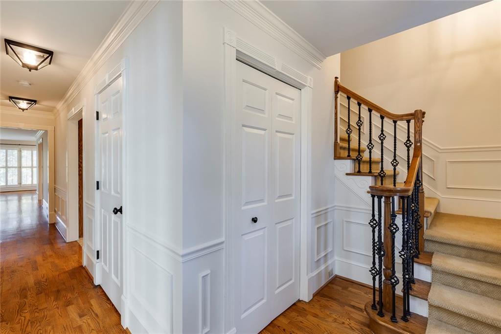 5377 Trentham Drive Dunwoody, GA 30338 - Photo 6 of 51 a view of a hallway with wooden floor and staircase