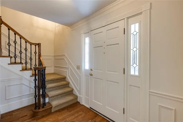 a view of entryway with wooden floor and stairs